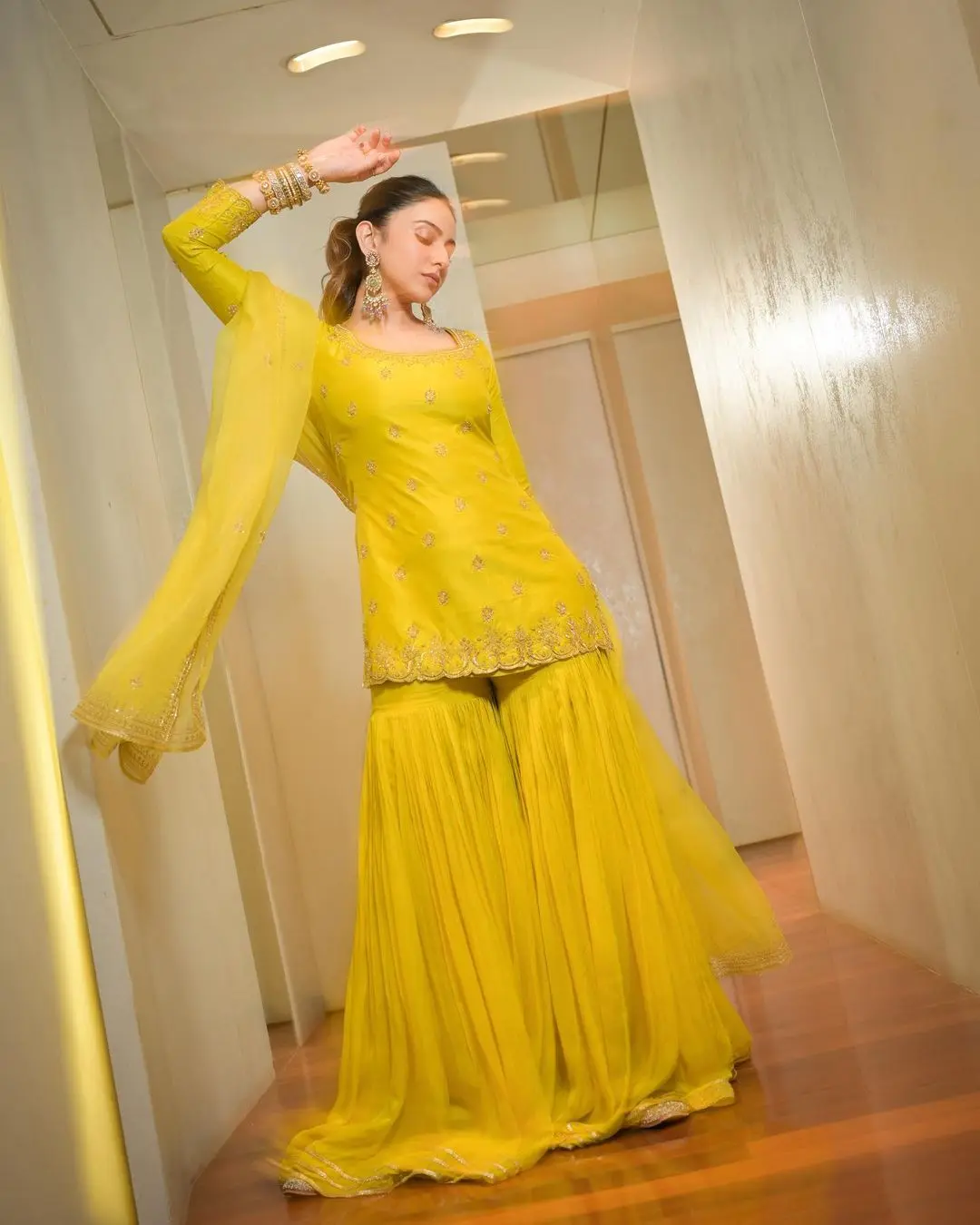Rakul looked absolutely gorgeous in a vibrant yellow sharara set with intricate gold embroidery.