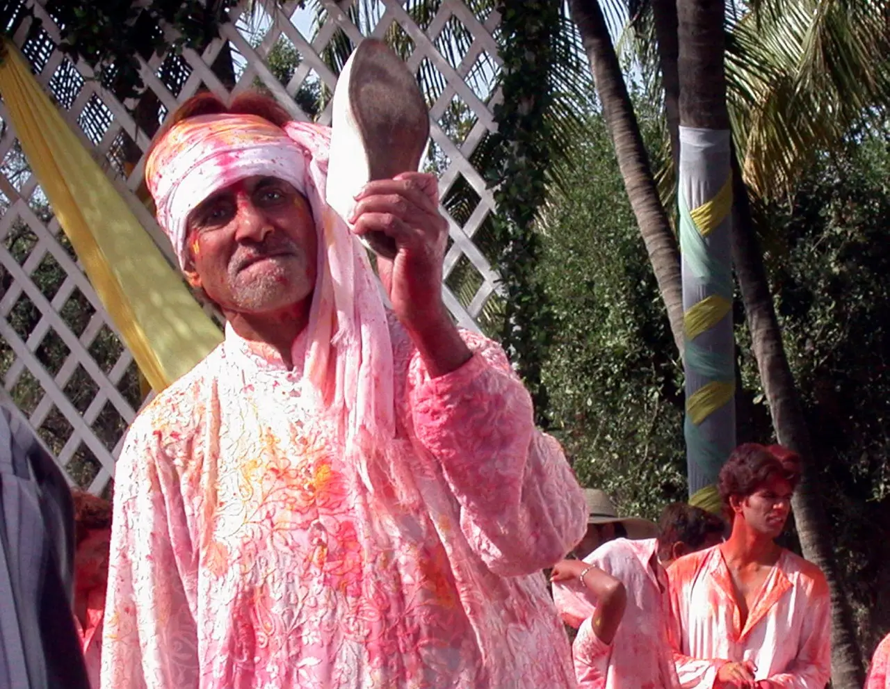Amitabh Bachchan and the festival of Holi are synonymous with his song, `Rang Barse` being a festival favourite. Here is a candid picture of the actor during Holi covered in colours and holding a shoe