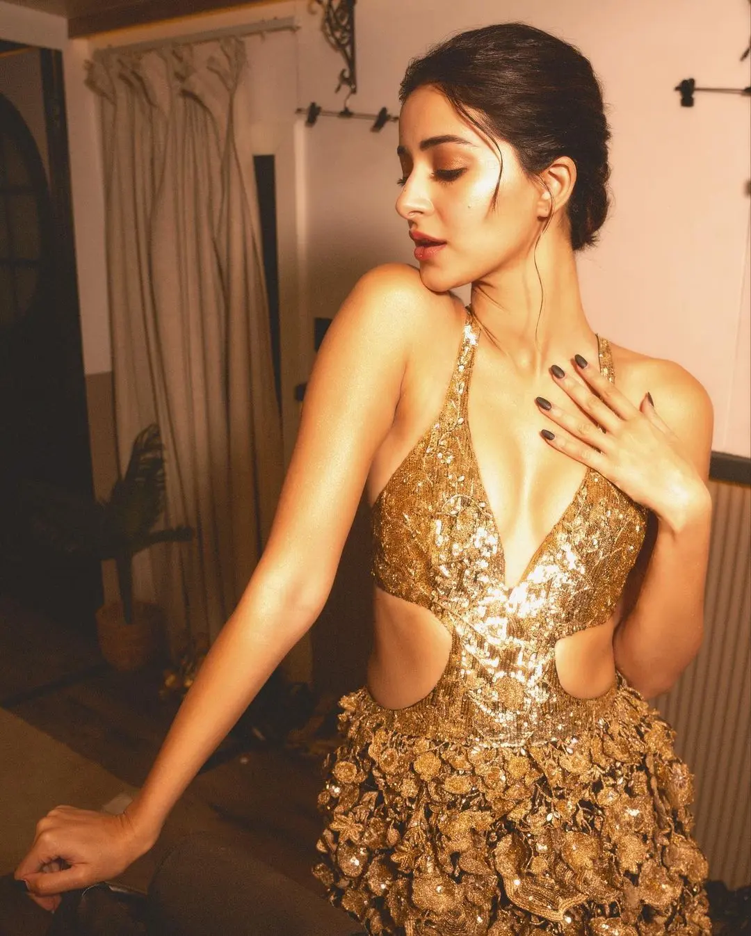 Ananya turned up the luxury factor in a stylish, shiny golden gown from Rahul Mishra. The dress had a deep neckline and eye-catching 3D flower decorations. It was strappy and had cutouts on the sides, and even the back had some strappy details.