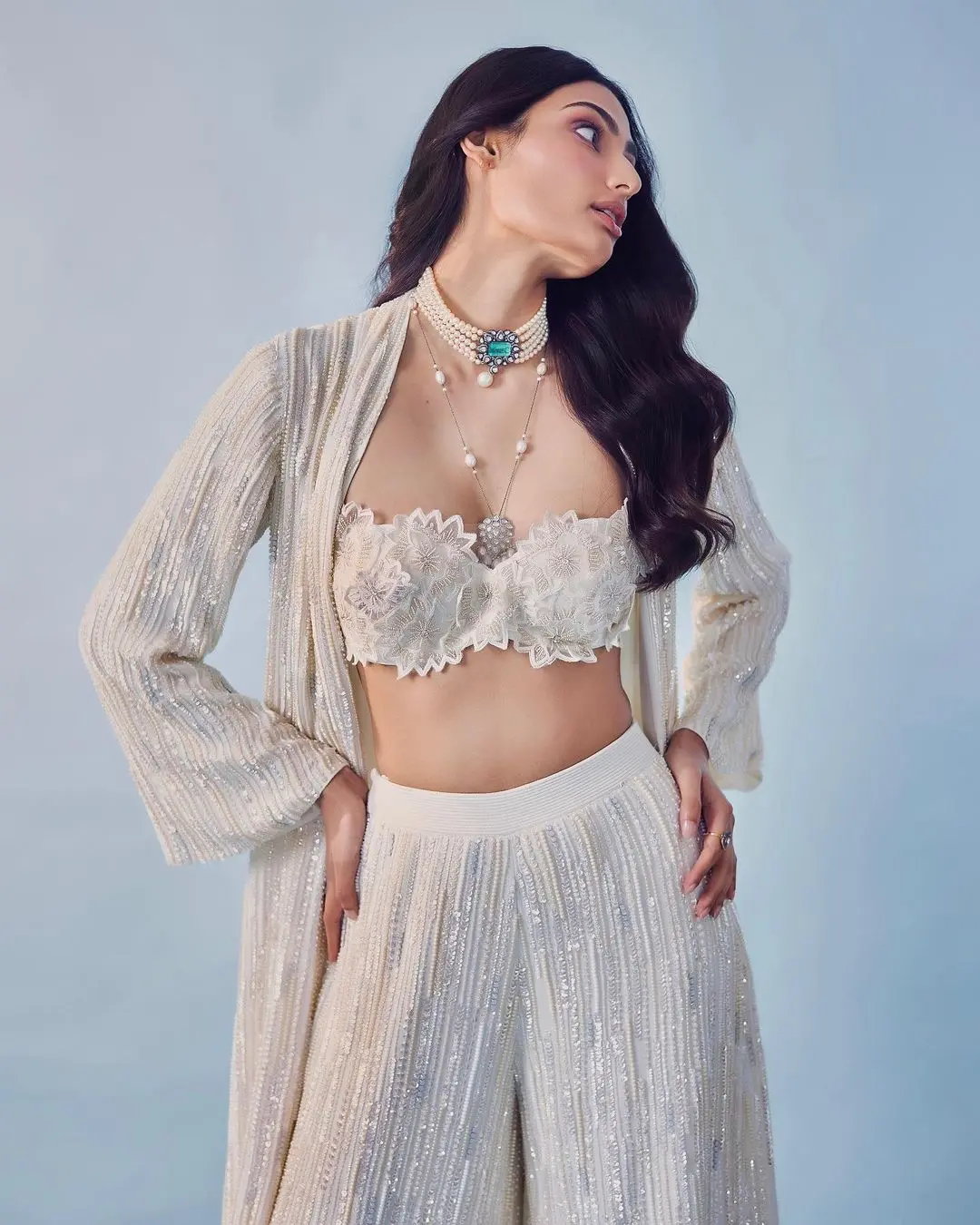 Over it, she had on a long jacket that matched the palazzo pants and was decorated with ivory sequins and pearls