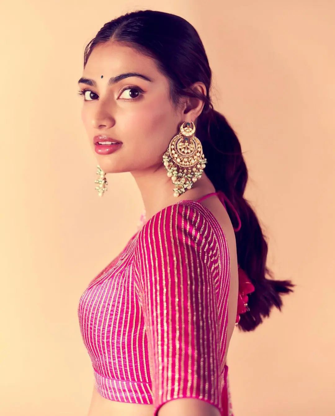 She paired the lehenga with statement jhumkas and a striking bindi