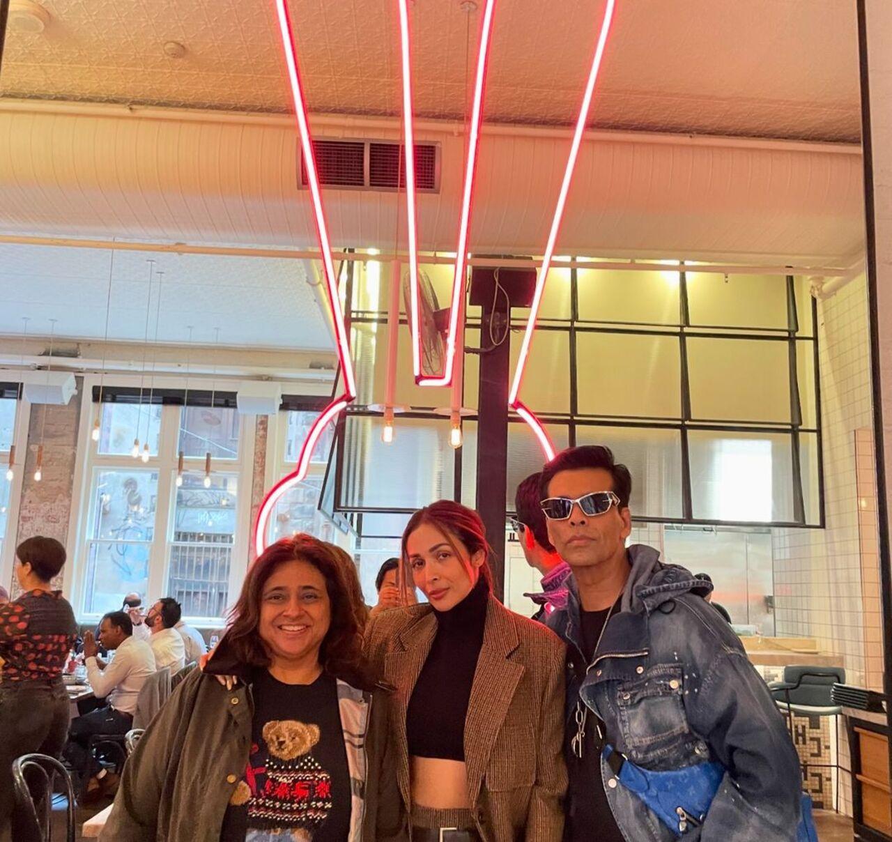 Karan Johar and Malaika Arora strike a pose together at a city restaurant.