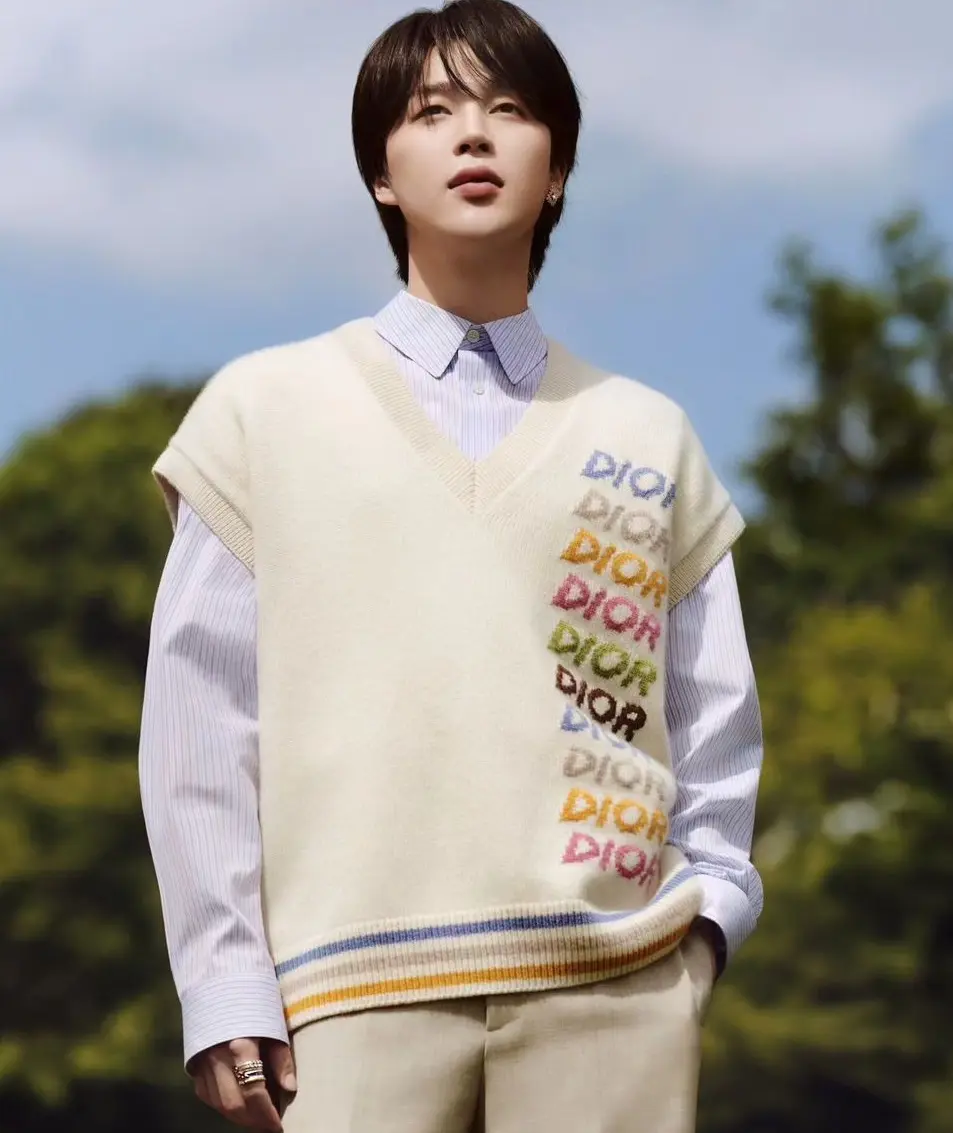 Now, in a Dior photoshoot, Jimin decided to mix things up a bit. He threw on a striped blue undershirt and casually draped a cream cardigan over it. This look is like the perfect blend of relaxed and high-end. It`s all about comfort with a side of style, and Jimin rocks it like a pro.