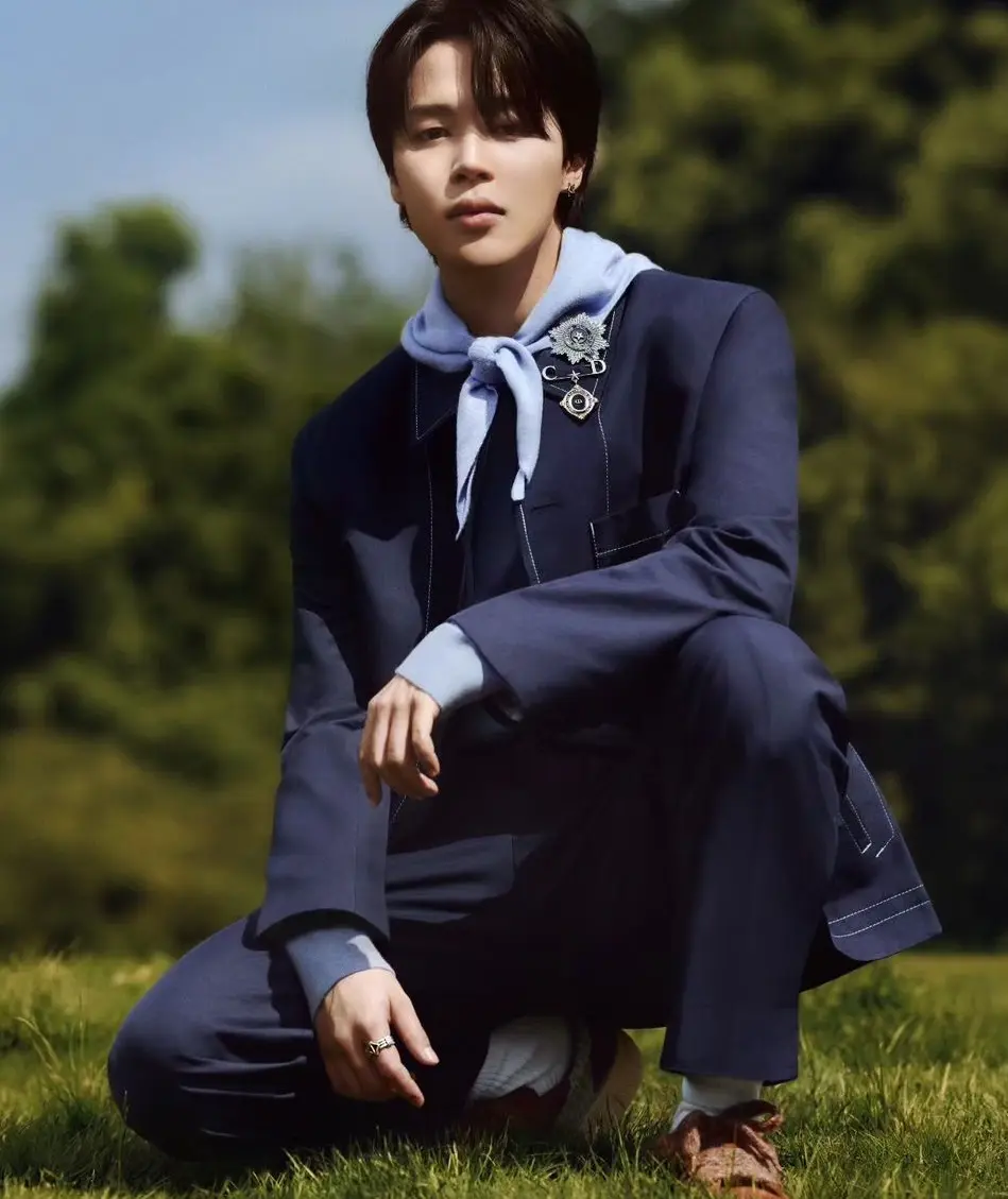 When Jimin wants to turn heads, he doesn`t mess around. Check out his blue suit with a light blue scarf tied around his neck. It`s the kind of outfit that makes people do a double-take. The blue-on-blue combo is just refreshing.