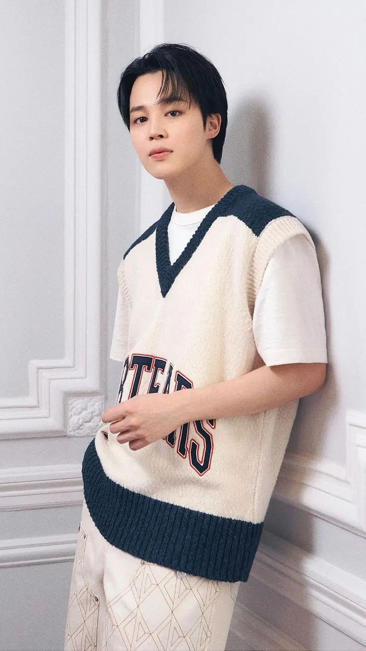 One picture that left fans in awe was Jimin donning a white ensemble with a cream-colored vest featuring green borders. 