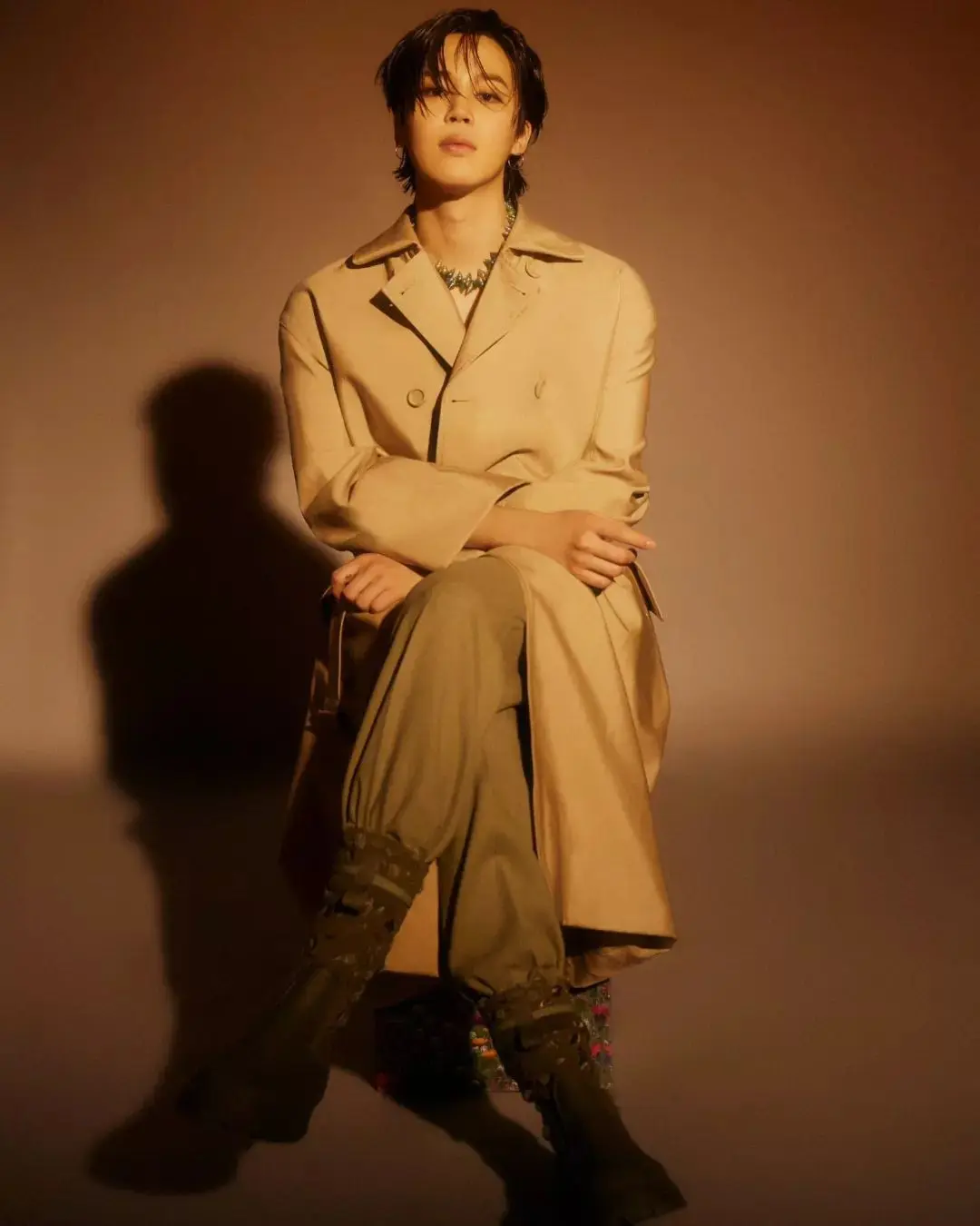 In another striking look, Jimin sported a brown ensemble with a beige-brown overcoat. The earthy tones gave him a warm aura