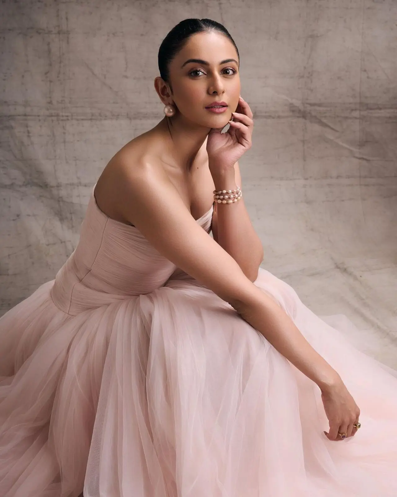 She neatly tied her hair up in a bun and completed the look with a pair of diamond studs