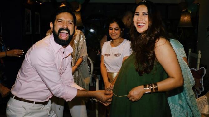 The couple caught in a candid moment from the baby showers