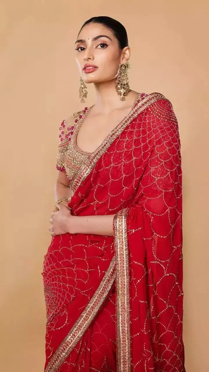If you`re a saree person, Athiya served the right style inspiration in a red saree paired with a golden blouse