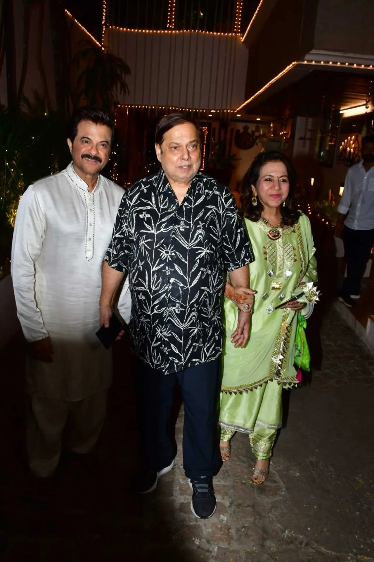 David Dhawan and his wife pose with Anil Kapoor at the latter`s residence