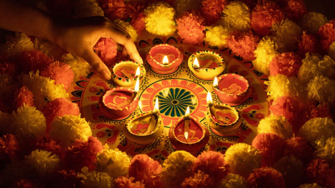 2. Lighting Earthen Lamps (Diyas)