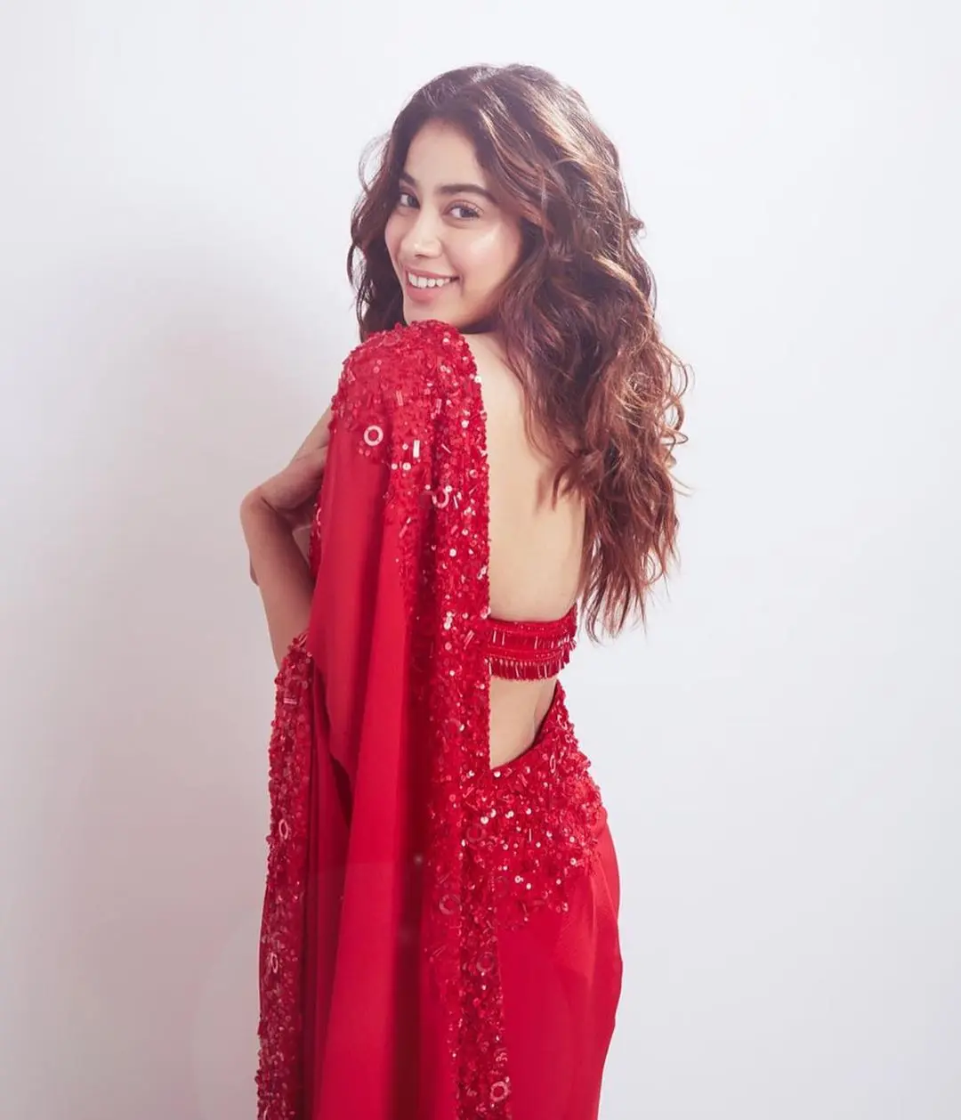 Janhvi Kapoor`s choice of a sultry red Manish Malhotra saree and blouse set couldn`t be more perfect for Navratri Day 2.