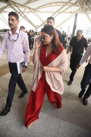 Parineeti was spotted wearing a peach shawl while wearing a red jumpsuit