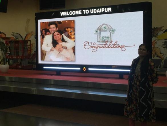 In one of the pictures, an LED board flashed a pic of the couple from their engagement day