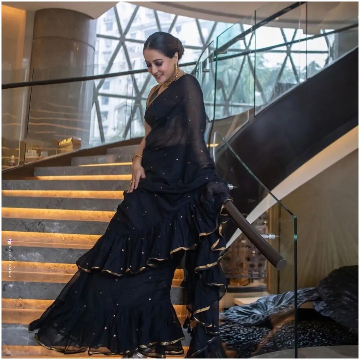 The saree adds drama to her otherwise classic look with ruffles on the edges. The actress tied up her hair and let the saree be in focus
