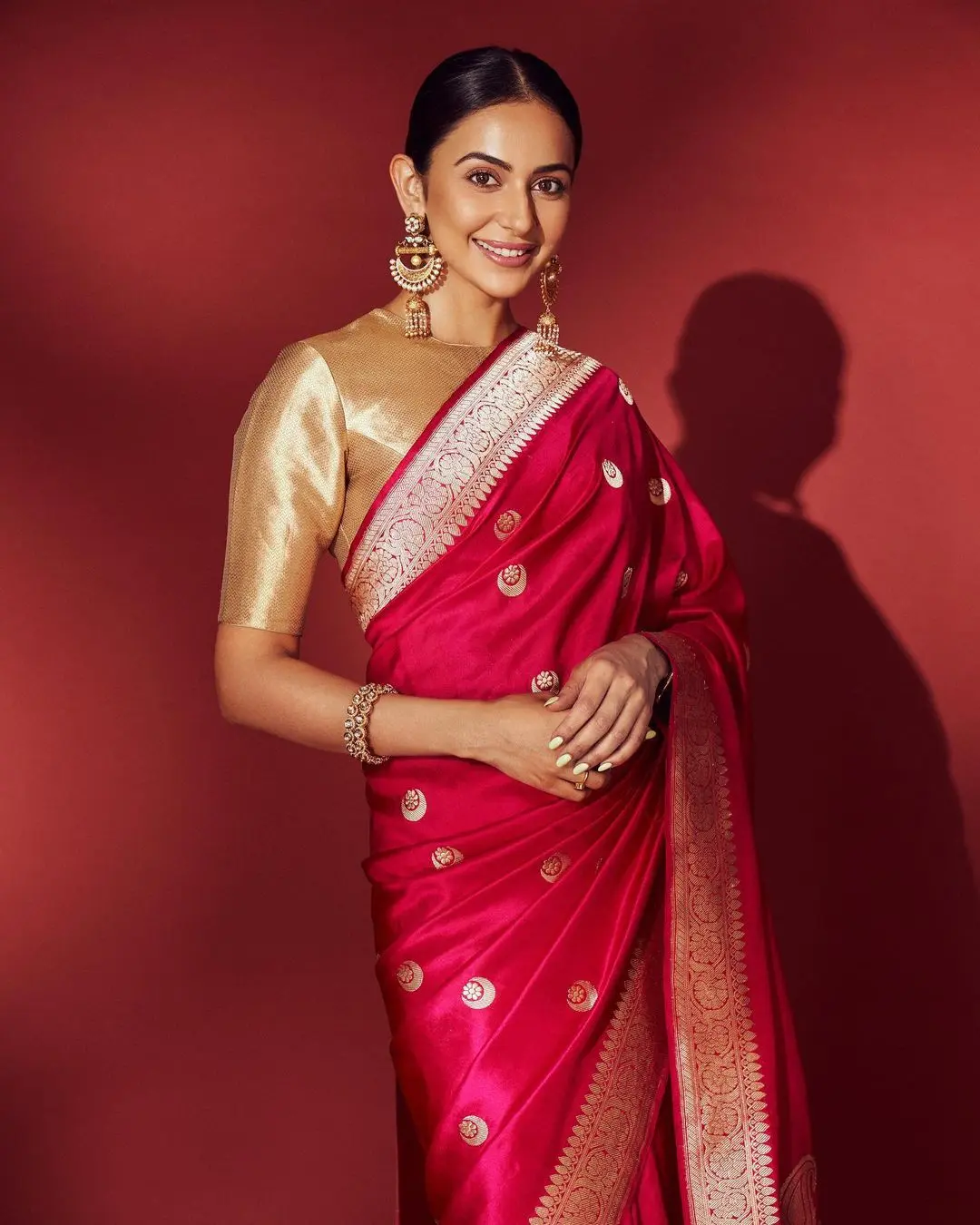 Her gold blouse had short sleeves, maintaining a modest yet elegant appearance.