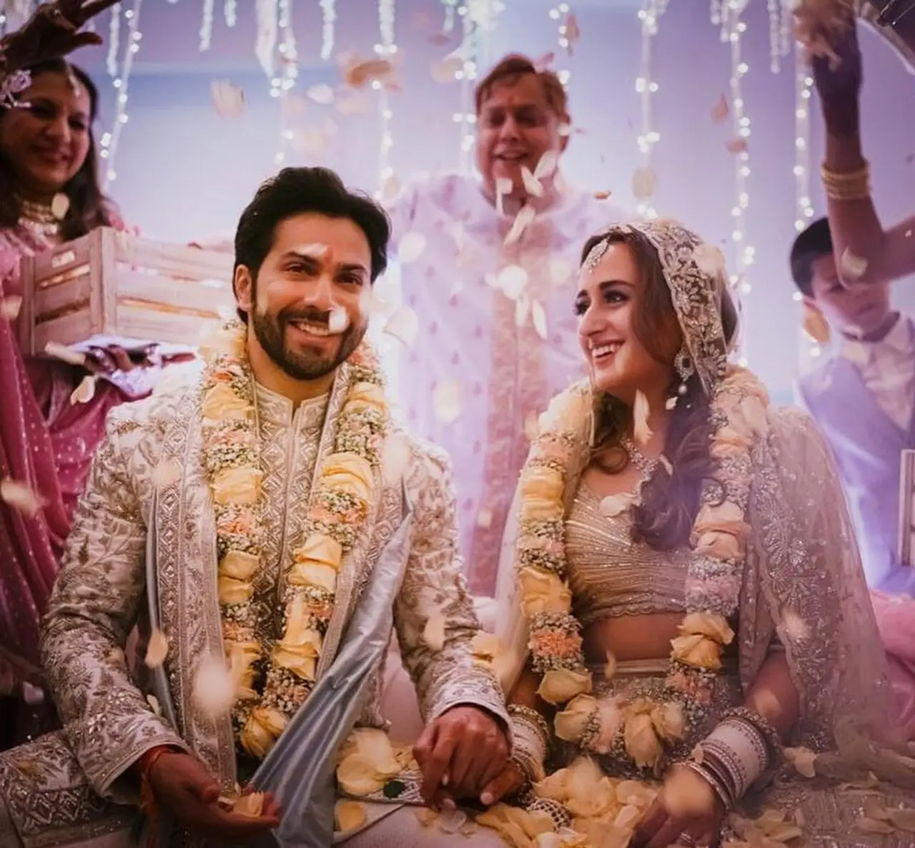Varun Dhawan`s bride, fashion designer Natasha Dalal, opted for a pastel embroidered lehenga for the big fat Punjabi wedding
