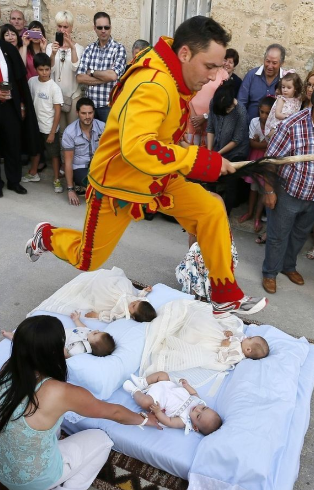 Held in Castrillo de Murcia, men dressed as devils leap over rows of babies to cleanse them of evil spirits—yes, it`s real!
