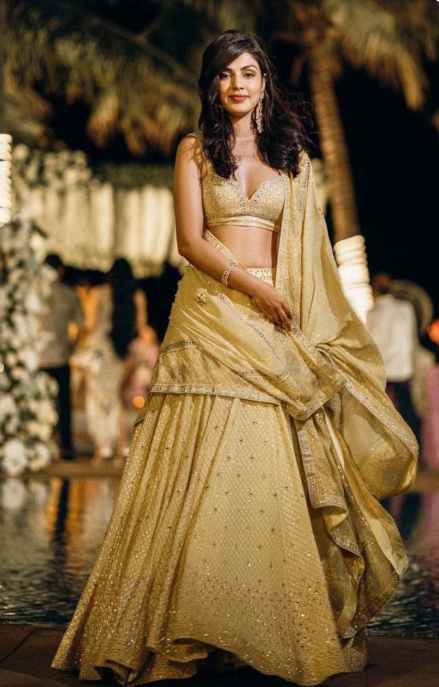 The Jalebi actress looks stunning in a golden yellow lehenga. Her subtle makeup and vibrant smile elevate the look.