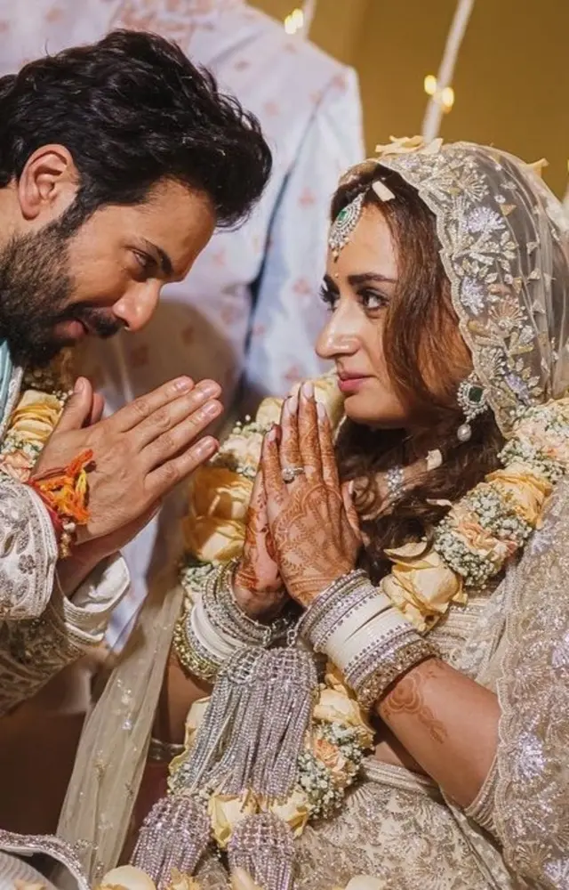 Varun Dhawan`s bride Natasha Dalal chose a silver lehenga by Manish Malhotra. She also paired it with a white choora, avoiding the usual red and gold theme.