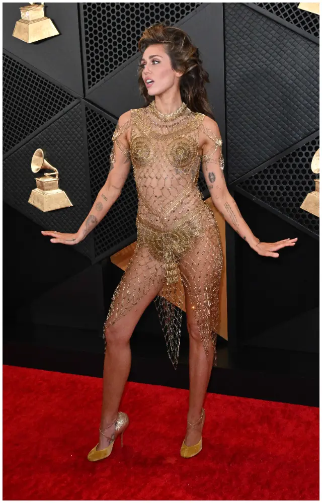 The look, which was custom, featured real metal safety pins and a slew of colourful beads. Miley finished off the look with Margiela Tabis footwear