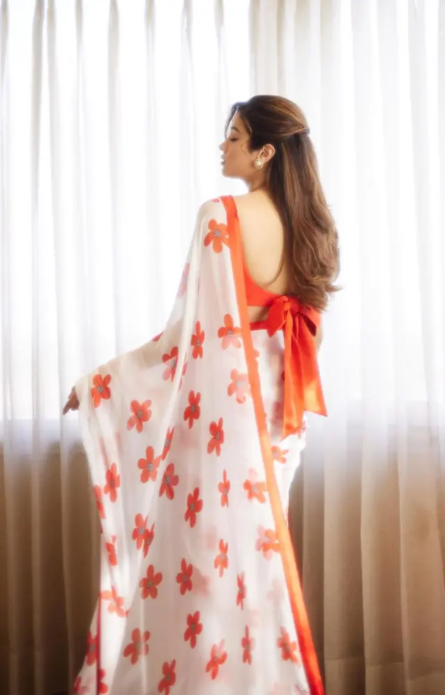 Her minimal yet elegant choice of accessories, including delicate pearl jewelry, perfectly complements the overall look