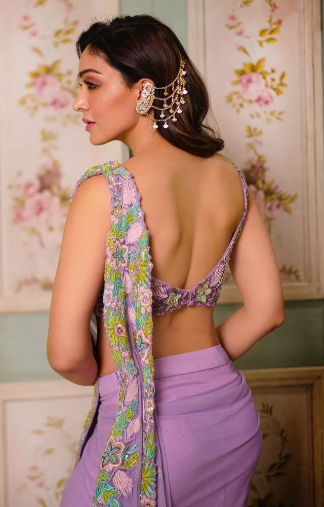 The otherwise calm saree was given the oomph factor with a backless blouse and a fun hair accessory