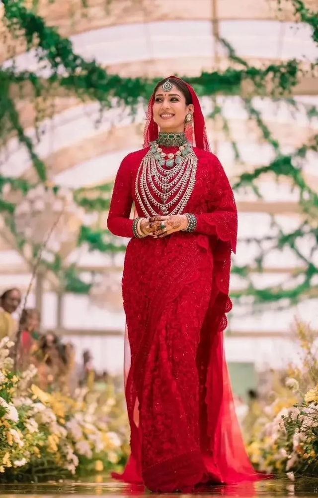 Nayanthara, wowed in a traditional red saree adorned with intricate gold embroidery. 