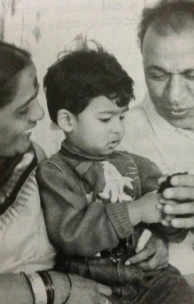 Puneeth Rajkumar, affectionately known as Appu, has adorable childhood photos where he is seen with a cheerful expression and curly hair.