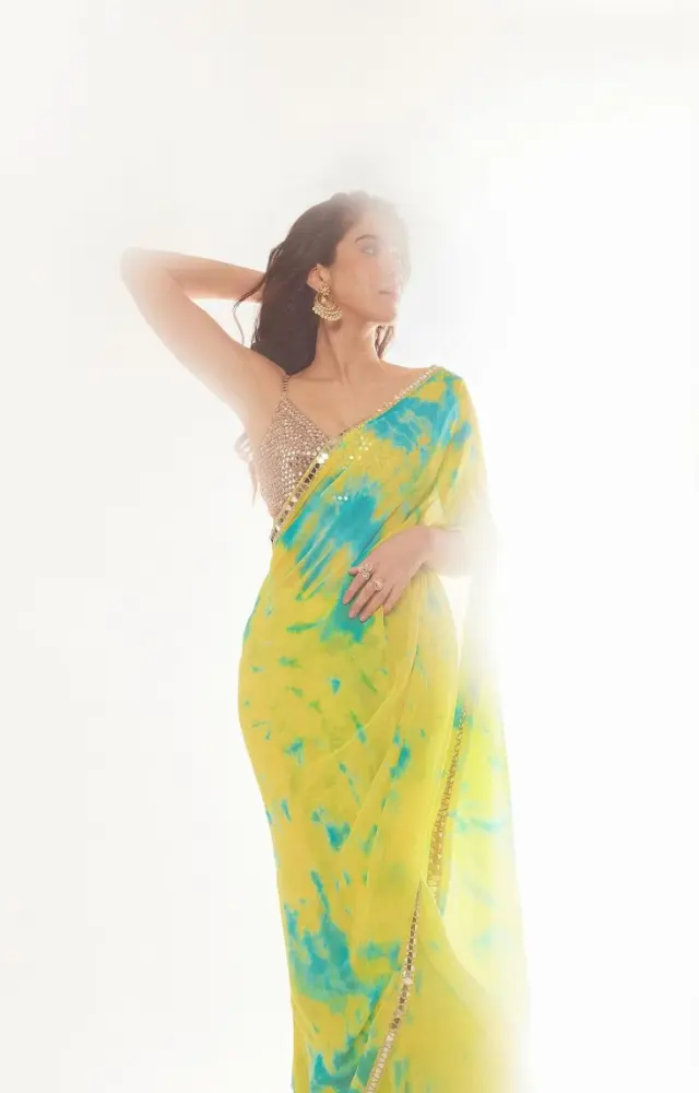 Shanaya Kapoor donned a vibrant yellow and blue tie-dye chiffon sari by Akanksha Gajria at her friend`s wedding celebrations.