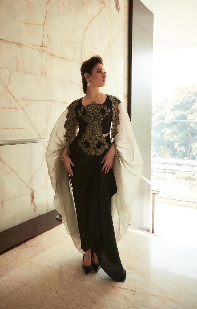 The actress also styled a sheer cape that featured similar threadwork