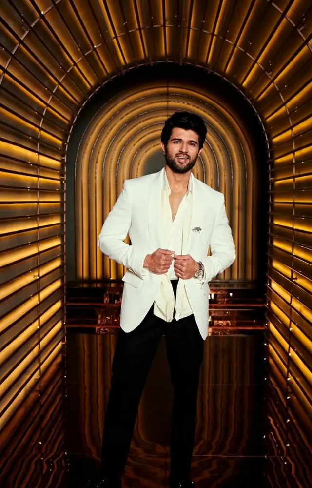 Vijay Deverakonda was seen wearing the white tuxedo suit as he made a stylish visit to the Koffee with Karan show, looking like a complete `Cheese Platter`.