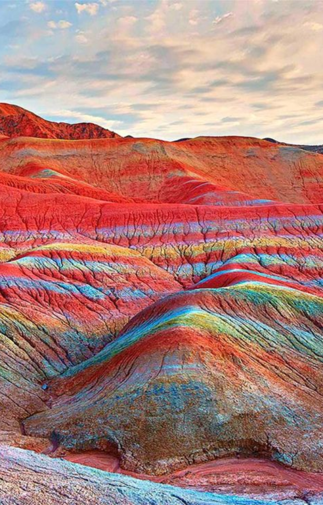 These rainbow-colored mountains look like a digital painting, but their vivid stripes come from layers of mineral deposits.
