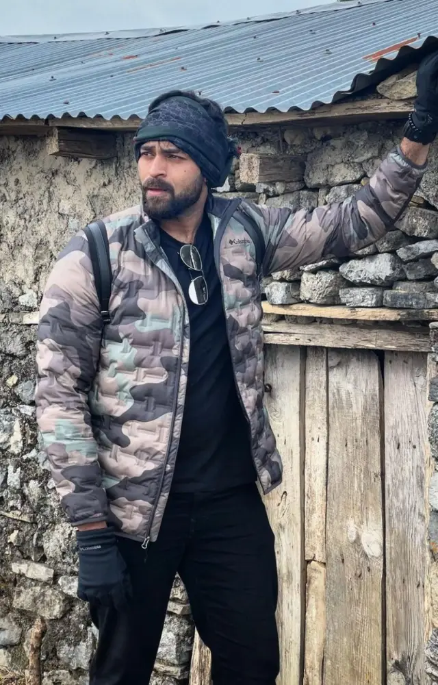Embrace the rugged charm of winter with Varun`s military-inspired look featuring a bold puffer jacket and a snug beanie
