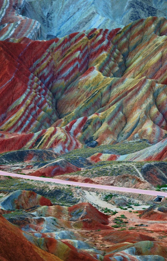 These rainbow-striped hills are made from layered sandstone and minerals over millions of years—no filters needed.
