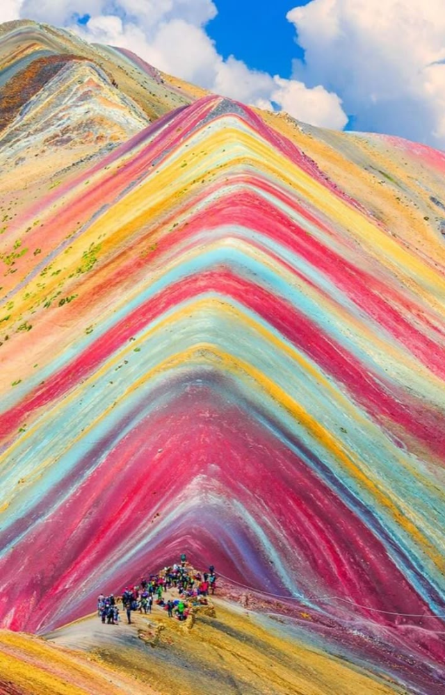 Located in the Andes, its bold red, gold, and turquoise bands come from sedimentary layering and mineral deposits.
