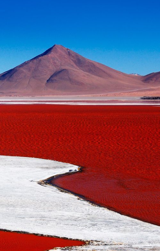 Algae and red sediments give this lake a fiery hue, especially in the dry season when minerals are more concentrated.
