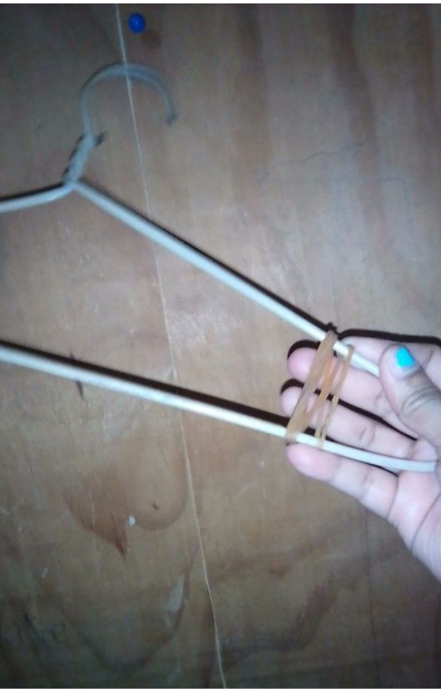 Wrap rubber bands on both ends of a hanger. This stops clothes from sliding off, keeping your closet tidy and your outfits wrinkle-free.
