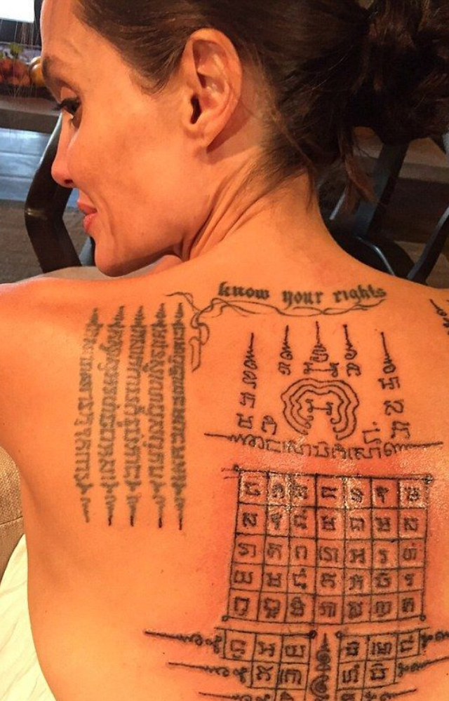 These intricate tattoos are blessed by monks and believed to grant strength, protection, and divine favor to the wearer.
