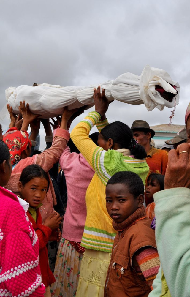 Families exhume the bones of ancestors, rewrap them in fresh cloth, and dance with them in celebration of life and memory.
