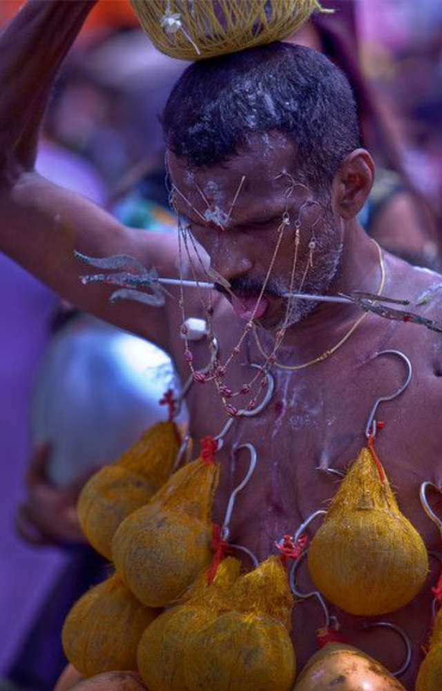 Devotees pierce their bodies with hooks, spikes, and skewers as an extreme form of penance and spiritual devotion.

