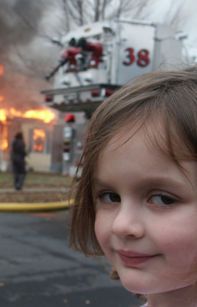 A young girl smiling in front of a burning house became a symbol for mischief and chaos.
