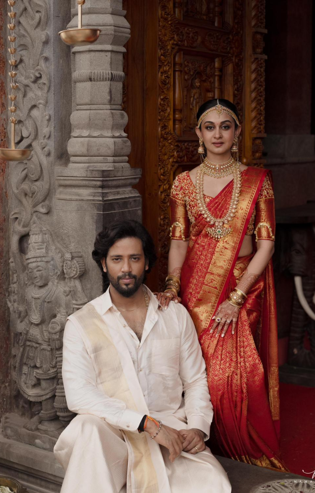 Umapathy donned a classic all-white dhoti and shirt ensemble, complementing Aishwarya, radiant in an exquisite red saree embellished with elegant jewelry