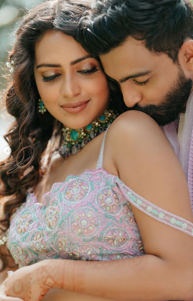 The newlyweds, Amala and Jagat, share a tender moment during their lavender themed ceremony.