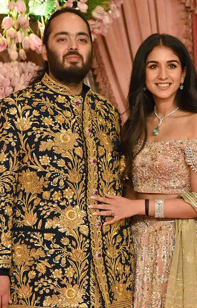 Anant Ambani, the groom-to-be, radiated regal charm in a midnight blue bandhgala adorned with intricate Persian garden motifs, featuring real gold zari