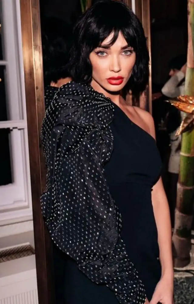 Amy frequently opts for the classic Little Black Dress (LBD), styling it impeccably for any event, showcasing elegance and sophistication.
