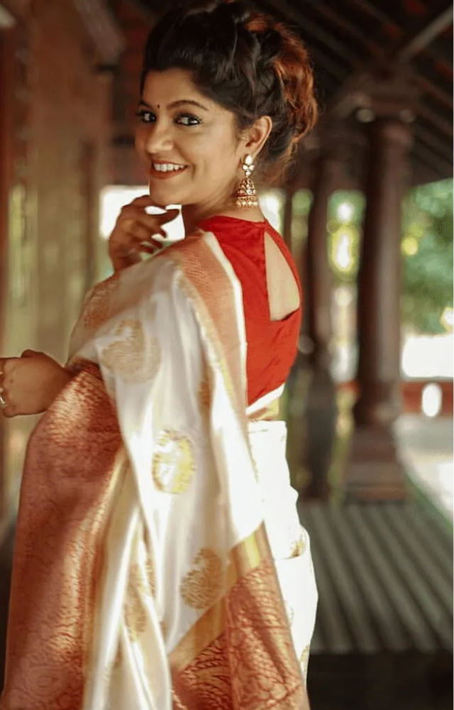 Her smile complements the saree perfectly, radiating warmth and joy, making her appearance even more captivating.

