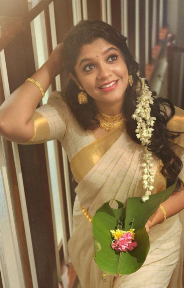 She carries herself with impeccable poise and posture, enhancing the saree`s beauty with her confident demeanor.

