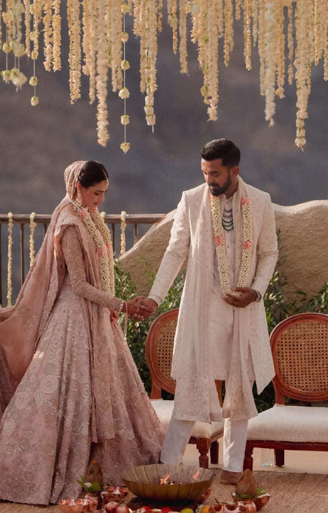 Athiya Shetty looked ethereal in her ivory bridal lehenga with intricate detailing designed by Anamika Khanna. She married cricketer KL Rahul in January 2023.