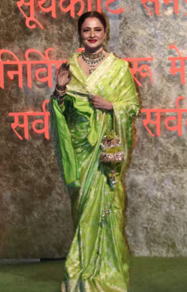 Rekha shone at Manish Malhotra’s Ganpati darshan in a lime green Kanjivaram saree, paired with gold jewelry and her iconic mogra gajra.
